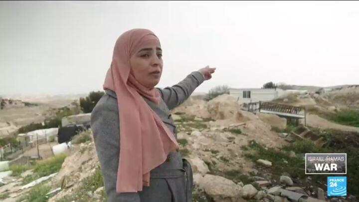 Palestinian land planner Safa Odeh points to a road in the West Bank.